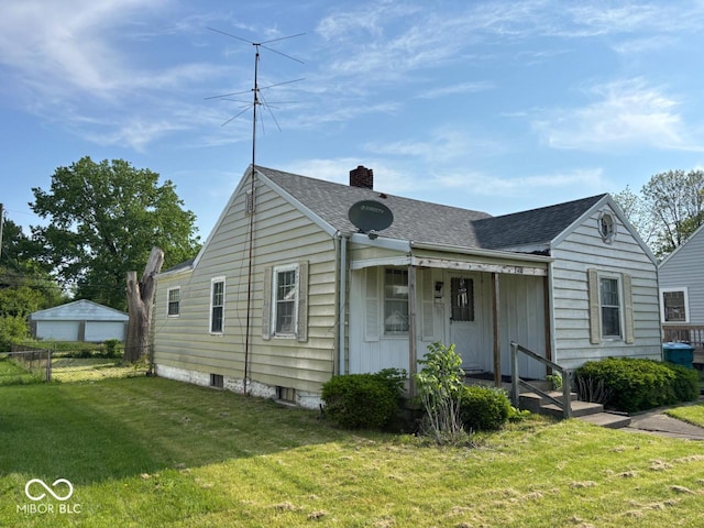 view of front of home featuring a shingled roof and a chimney