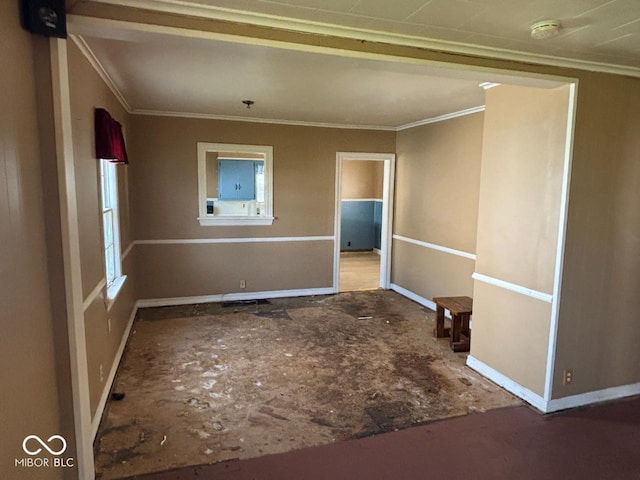 unfurnished room with a smoke detector, crown molding, and baseboards