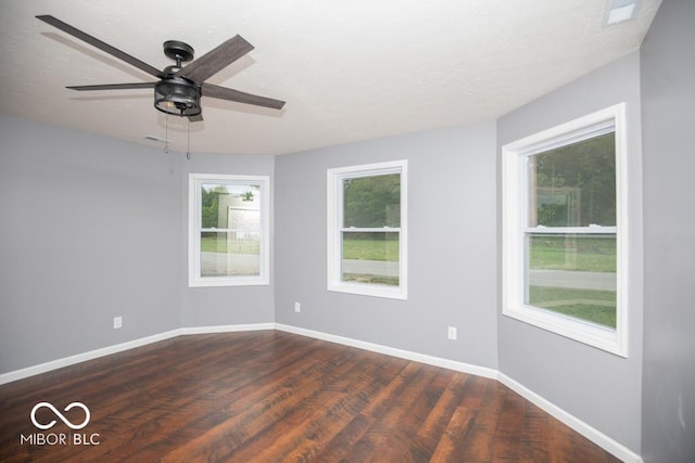6805 N Base Rd, North Vernon, IN 47265 - unfurnished room featuring dark wood finished floors, a ceiling fan, and baseboards