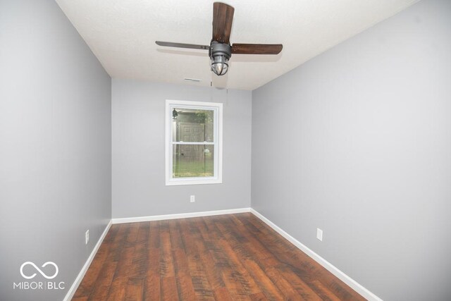 6805 N Base Rd, North Vernon, IN 47265 - spare room with baseboards, dark wood-type flooring, and a ceiling fan