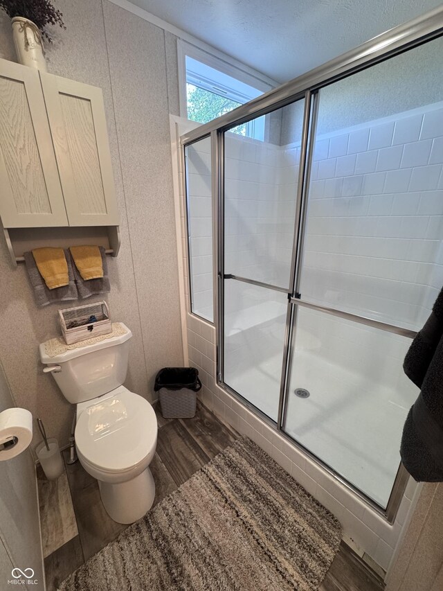 216 E Wabash St, Wingate, IN 47994 - full bath with wood finished floors, a shower stall, and toilet