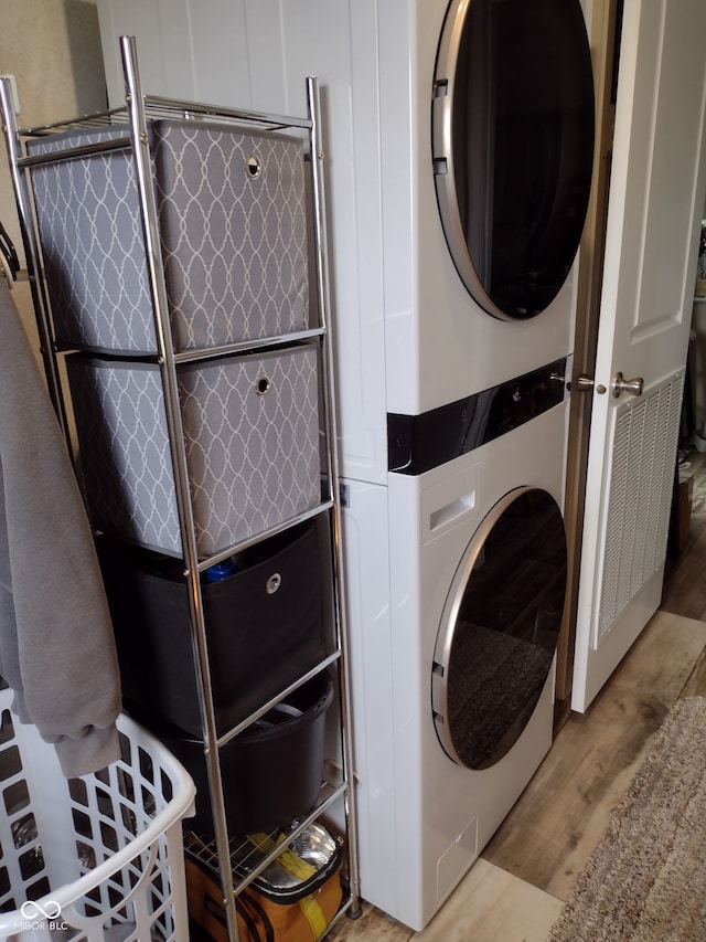 216 E Wabash St, Wingate, IN 47994 - laundry area with estacked washer and dryer and wood finished floors