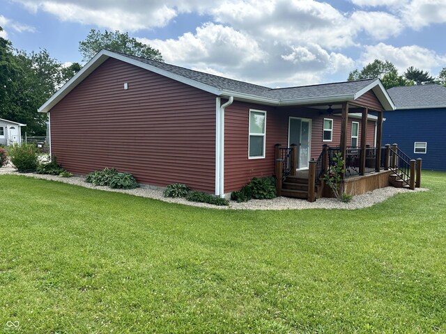 346 W N St, Gosport, IN 47433 - view of side of property featuring a lawn, roof with shingles, and covered porch