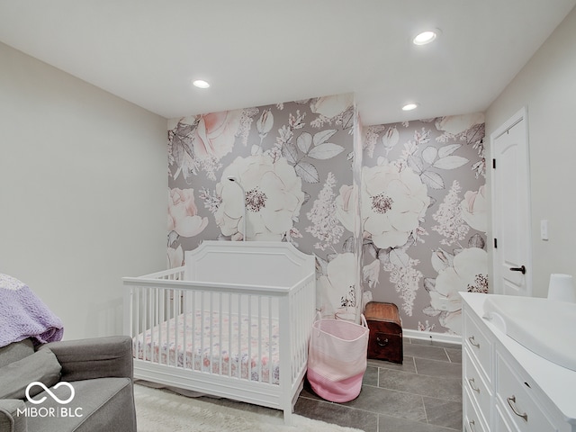 3659 Watson Rd, Indianapolis, IN 46205 - tiled bedroom featuring recessed lighting, a sink, baseboards, a nursery area, and wallpapered walls