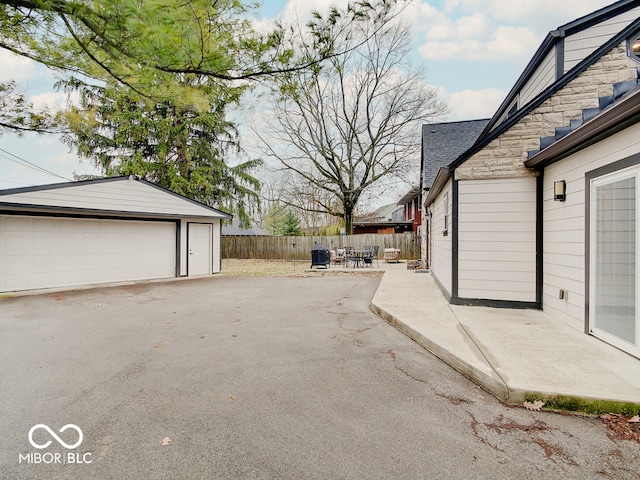 3659 Watson Rd, Indianapolis, IN 46205 - view of patio with a detached garage, fence, and an outdoor structure