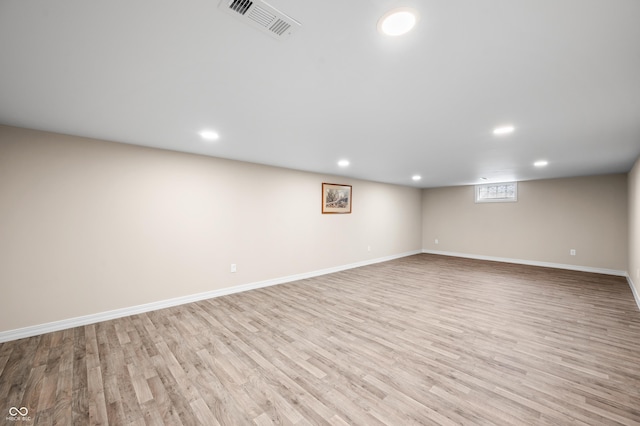 basement featuring light wood-type flooring, recessed lighting, and baseboards