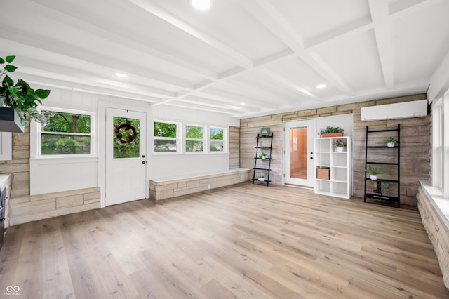 unfurnished living room with wood finished floors, a wall mounted air conditioner, wood walls, french doors, and beamed ceiling