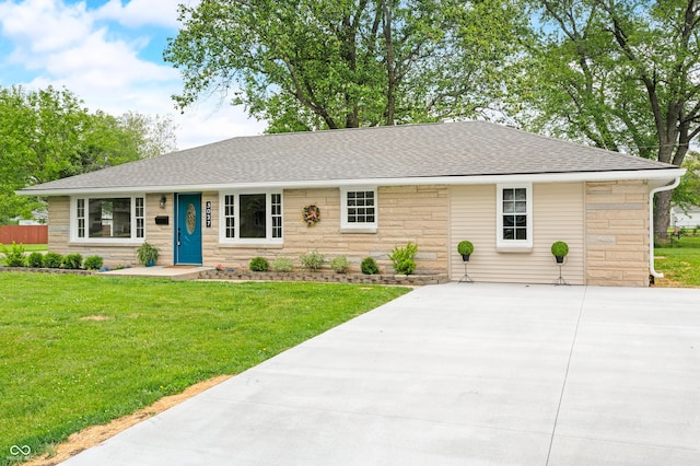 single story home featuring stone siding, a shingled roof, concrete driveway, and a front yard