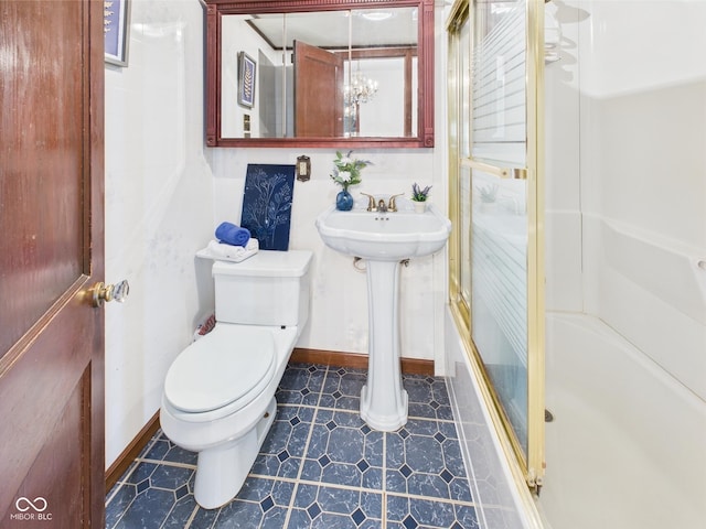 814 Walnut St, Anderson, IN 46012 - bathroom featuring a shower stall, toilet, and baseboards