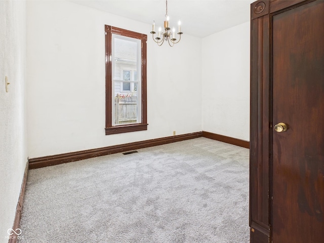 814 Walnut St, Anderson, IN 46012 - carpeted spare room featuring a chandelier and baseboards
