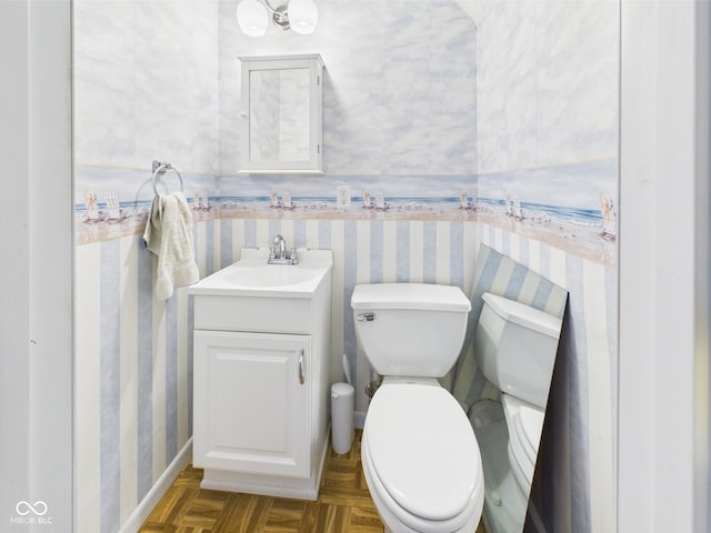 814 Walnut St, Anderson, IN 46012 - bathroom featuring wallpapered walls, baseboards, toilet, and vanity