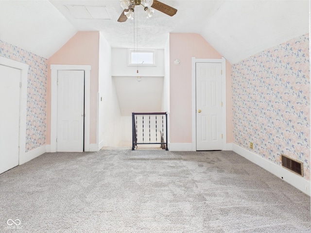 814 Walnut St, Anderson, IN 46012 - additional living space featuring wallpapered walls, lofted ceiling, a ceiling fan, and carpet
