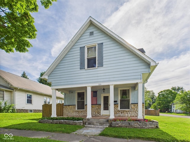 814 Walnut St, Anderson, IN 46012 - view of front of house featuring a porch, stone siding, and board and batten siding