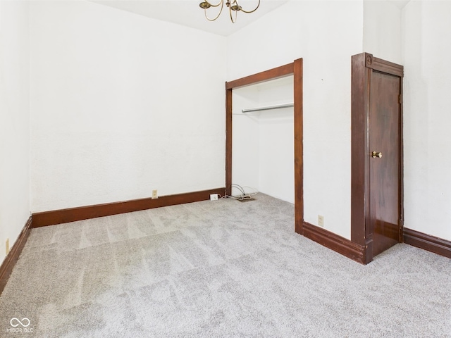 814 Walnut St, Anderson, IN 46012 - spare room with carpet floors, a chandelier, and baseboards