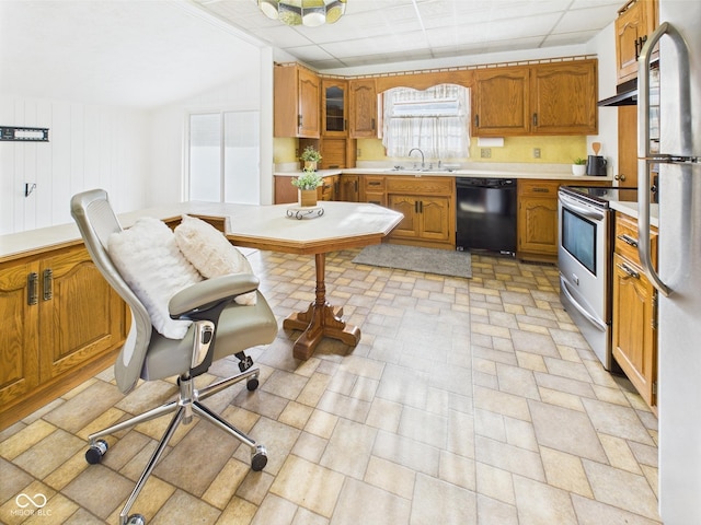 814 Walnut St, Anderson, IN 46012 - kitchen with appliances with stainless steel finishes, a sink, light countertops, and brown cabinetry