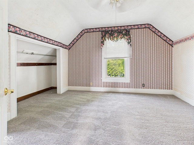 814 Walnut St, Anderson, IN 46012 - additional living space with vaulted ceiling, carpet flooring, wallpapered walls, a ceiling fan, and baseboards