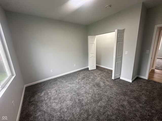 223 N Coventry Dr, Anderson, IN 46012 - unfurnished bedroom featuring dark colored carpet and baseboards