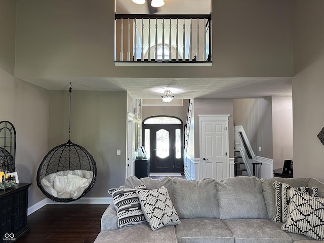 living area featuring stairway, wood finished floors, and baseboards