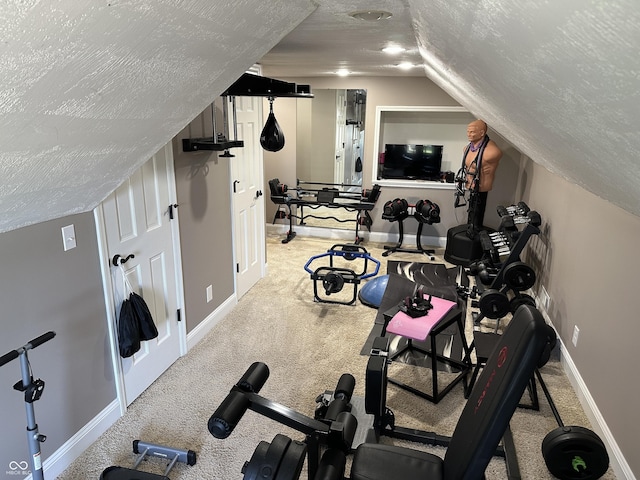 workout room featuring a textured ceiling, carpet flooring, baseboards, and lofted ceiling