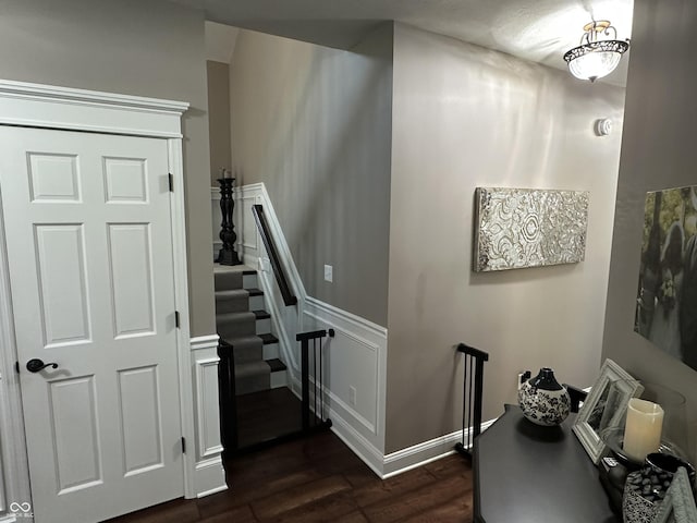 stairs featuring wood finished floors and baseboards