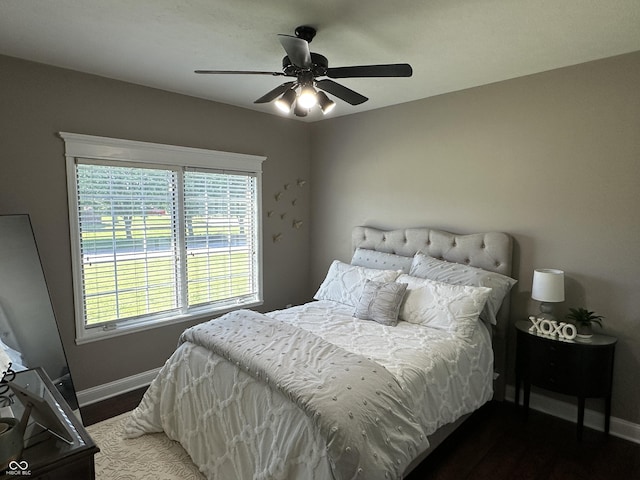 bedroom with baseboards, wood finished floors, and ceiling fan