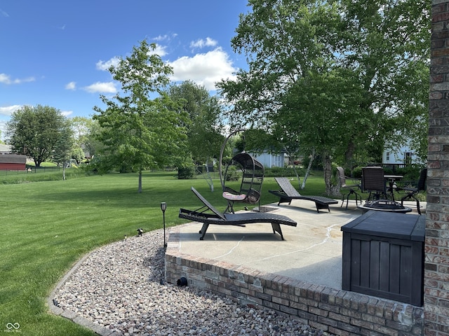 view of home's community featuring a lawn and a patio