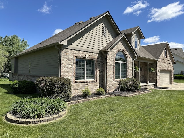 view of front of house featuring brick siding, a front yard, and an attached garage