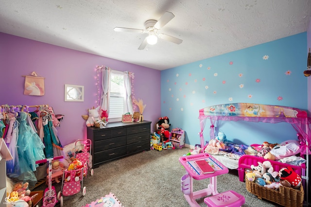 carpeted bedroom featuring a textured ceiling, ceiling fan, and wallpapered walls