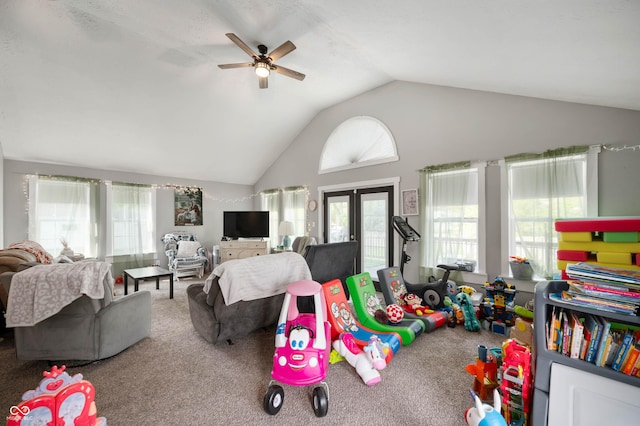 recreation room with carpet floors, vaulted ceiling, a ceiling fan, and french doors