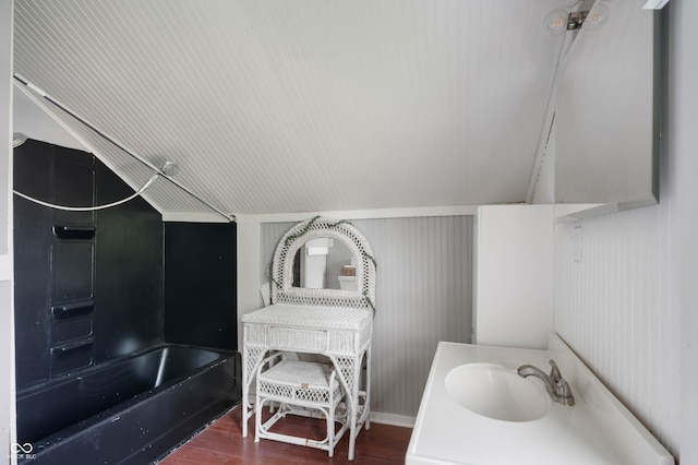 bathroom with wood finished floors, vanity, and shower / washtub combination