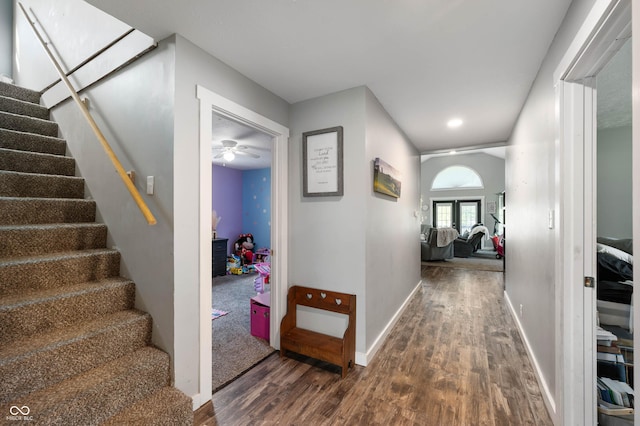 hall featuring wood finished floors, stairway, and baseboards
