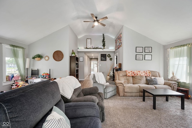 living room featuring lofted ceiling, a ceiling fan, and carpet floors