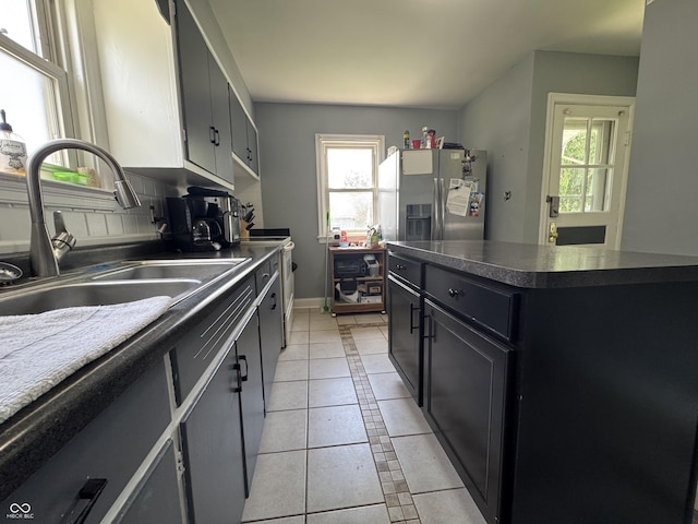 144 S 7th Ave, Beech Grove, IN 46107 - kitchen with a sink, stainless steel refrigerator with ice dispenser, healthy amount of natural light, and light tile patterned floors