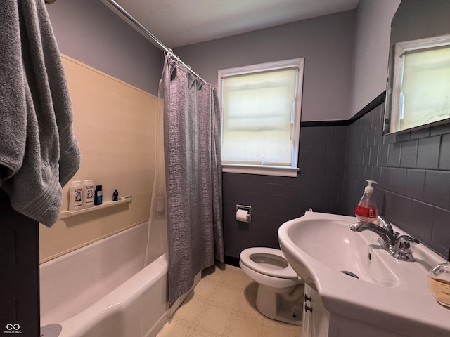 144 S 7th Ave, Beech Grove, IN 46107 - full bathroom featuring tile patterned floors, toilet, tile walls, shower / bath combo with shower curtain, and vanity