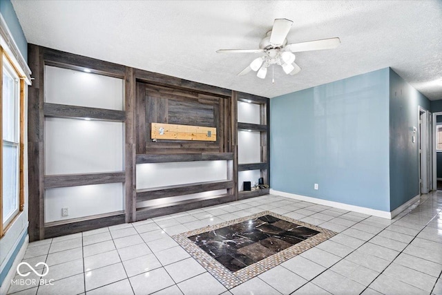 1170 N Concord St, Indianapolis, IN 46222 - unfurnished living room with a textured ceiling, tile patterned flooring, a ceiling fan, and baseboards