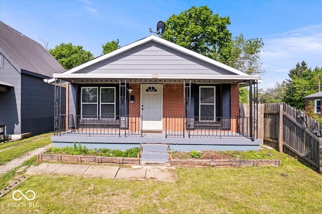 1170 N Concord St, Indianapolis, IN 46222 - view of front facade featuring brick siding and covered porch