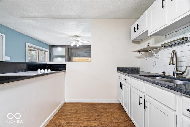1170 N Concord St, Indianapolis, IN 46222 - kitchen featuring a sink, a textured ceiling, a ceiling fan, white cabinets, and dark stone counters