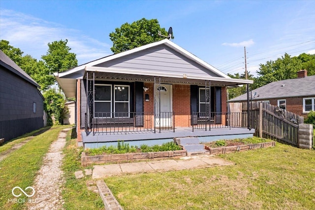 1170 N Concord St, Indianapolis, IN 46222 - view of front of house featuring brick siding and a porch