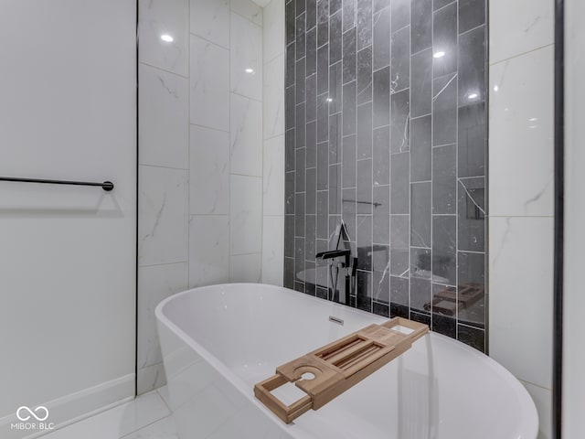 222 N E St Unit 103, Indianapolis, IN 46204 - full bath with a freestanding tub and tile walls