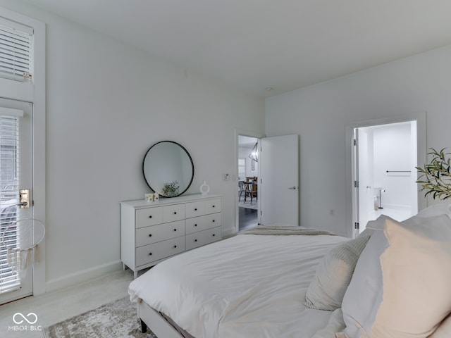 222 N E St Unit 103, Indianapolis, IN 46204 - bedroom featuring light carpet and baseboards