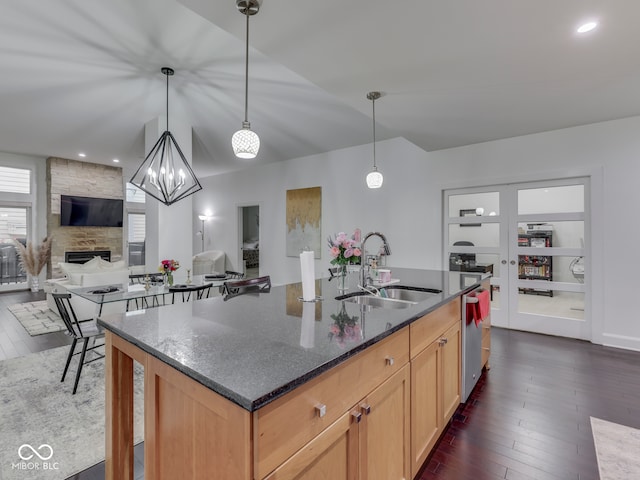 222 N E St Unit 103, Indianapolis, IN 46204 - kitchen featuring a sink, dark wood-type flooring, a fireplace, dark stone countertops, and recessed lighting