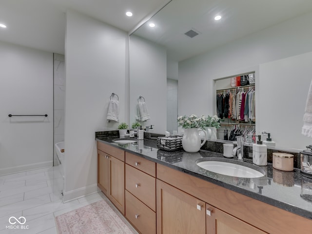 222 N E St Unit 103, Indianapolis, IN 46204 - full bathroom featuring double vanity, recessed lighting, and marble look tile flooring