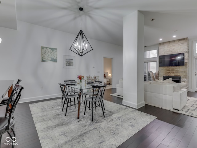 222 N E St Unit 103, Indianapolis, IN 46204 - dining room featuring dark wood-type flooring, baseboards, a fireplace, recessed lighting, and a chandelier