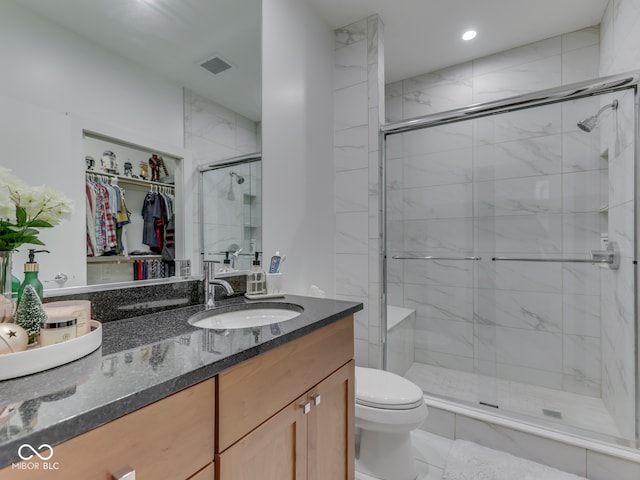 222 N E St Unit 103, Indianapolis, IN 46204 - bathroom with a stall shower, toilet, vanity, recessed lighting, and a walk in closet