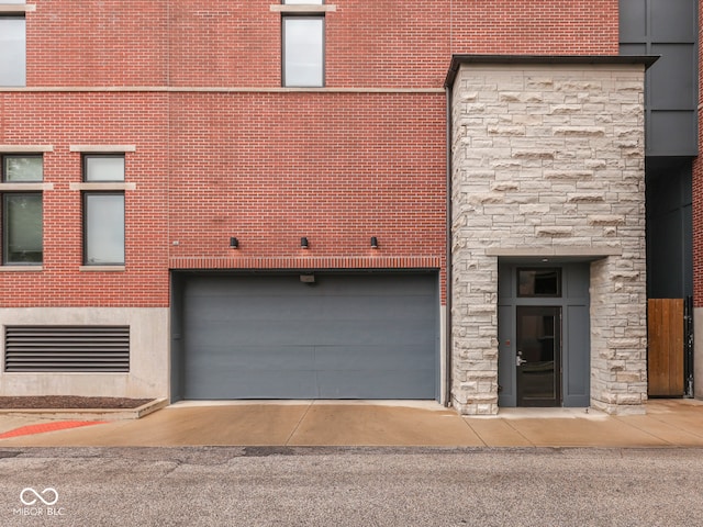 222 N E St Unit 103, Indianapolis, IN 46204 - view of property featuring a garage