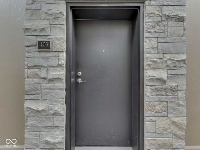 222 N E St Unit 103, Indianapolis, IN 46204 - view of exterior entry featuring stone siding
