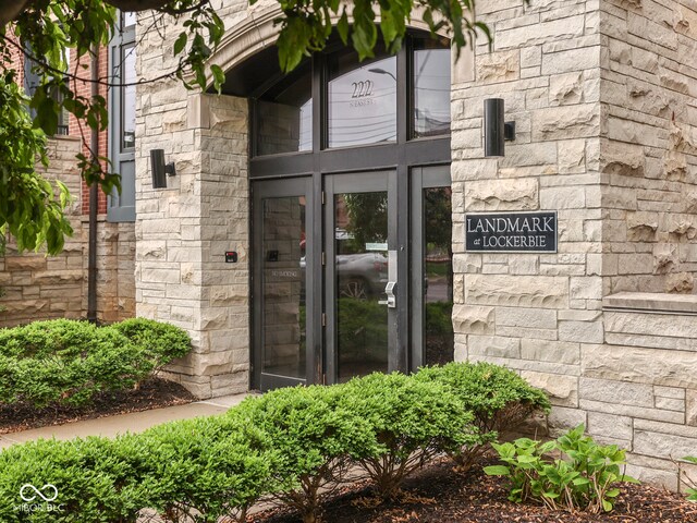 222 N E St Unit 103, Indianapolis, IN 46204 - doorway to property with stone siding