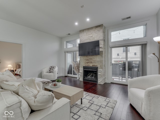 222 N E St Unit 103, Indianapolis, IN 46204 - living area featuring a fireplace, dark wood finished floors, and plenty of natural light