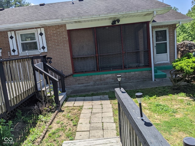 7114 Locust Lake W Dr, Spencer, IN 47460 - view of property exterior with brick siding, a shingled roof, a sunroom, and a yard
