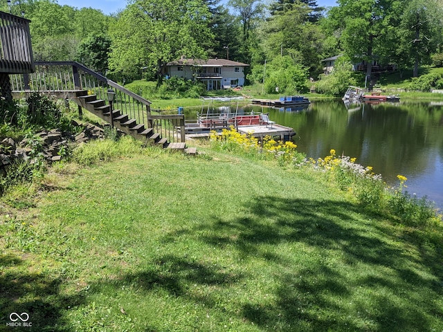 7114 Locust Lake W Dr, Spencer, IN 47460 - view of grassy yard featuring stairs, a water view, a dock, and a view of trees